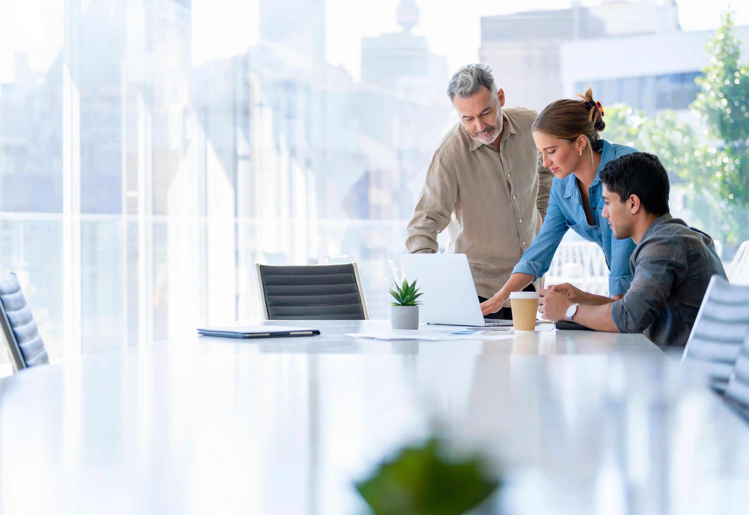 Business professionals reviewing work together in a boardroom